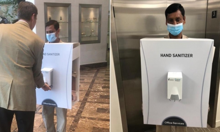 عامل يرتدي صندوق تعقيم ضد الكورونا للموظفين